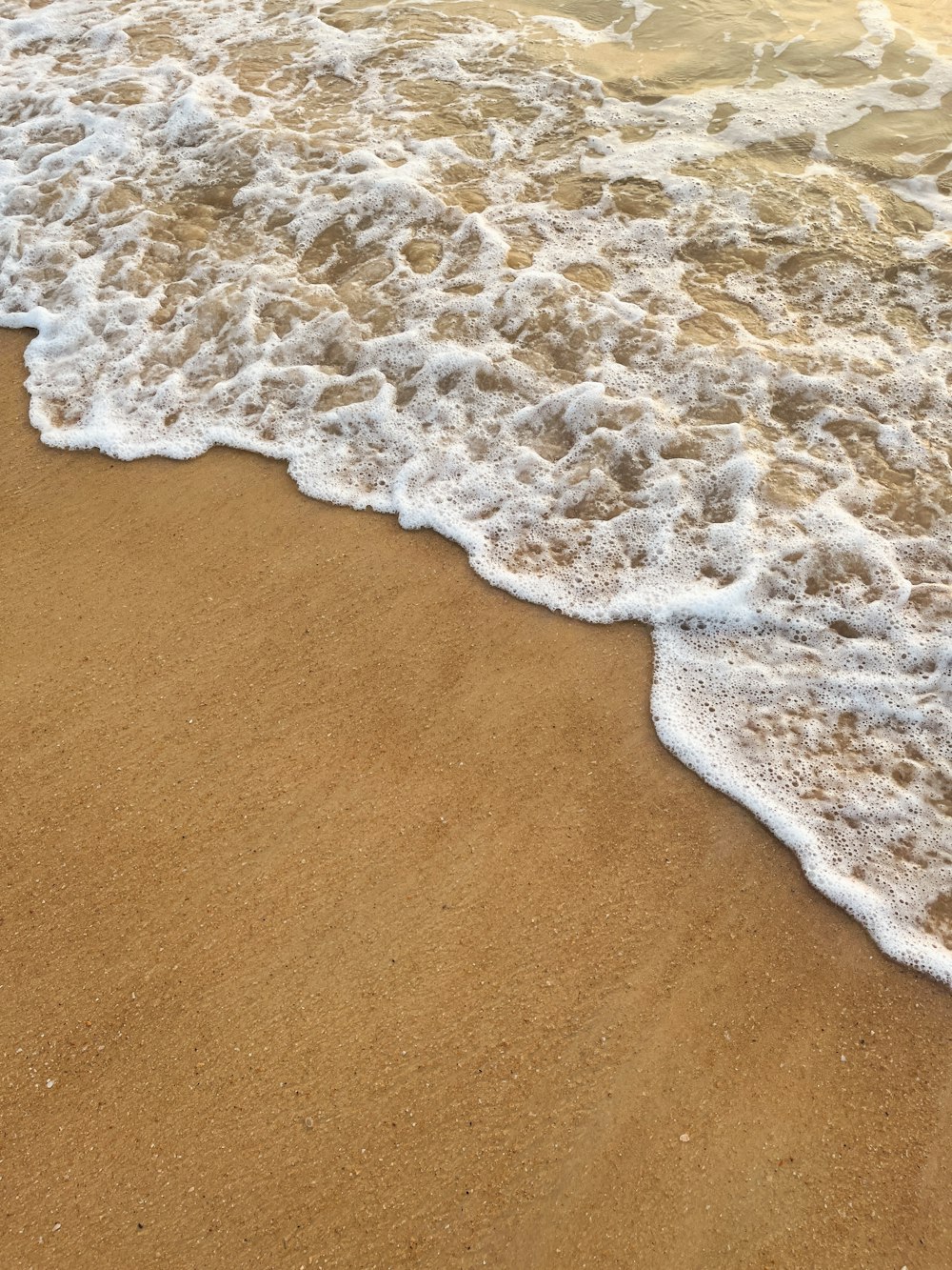 a close up of a wave on a beach