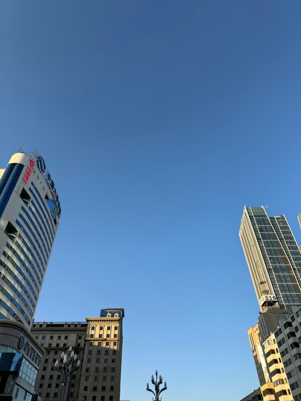 a clear blue sky over a city with tall buildings