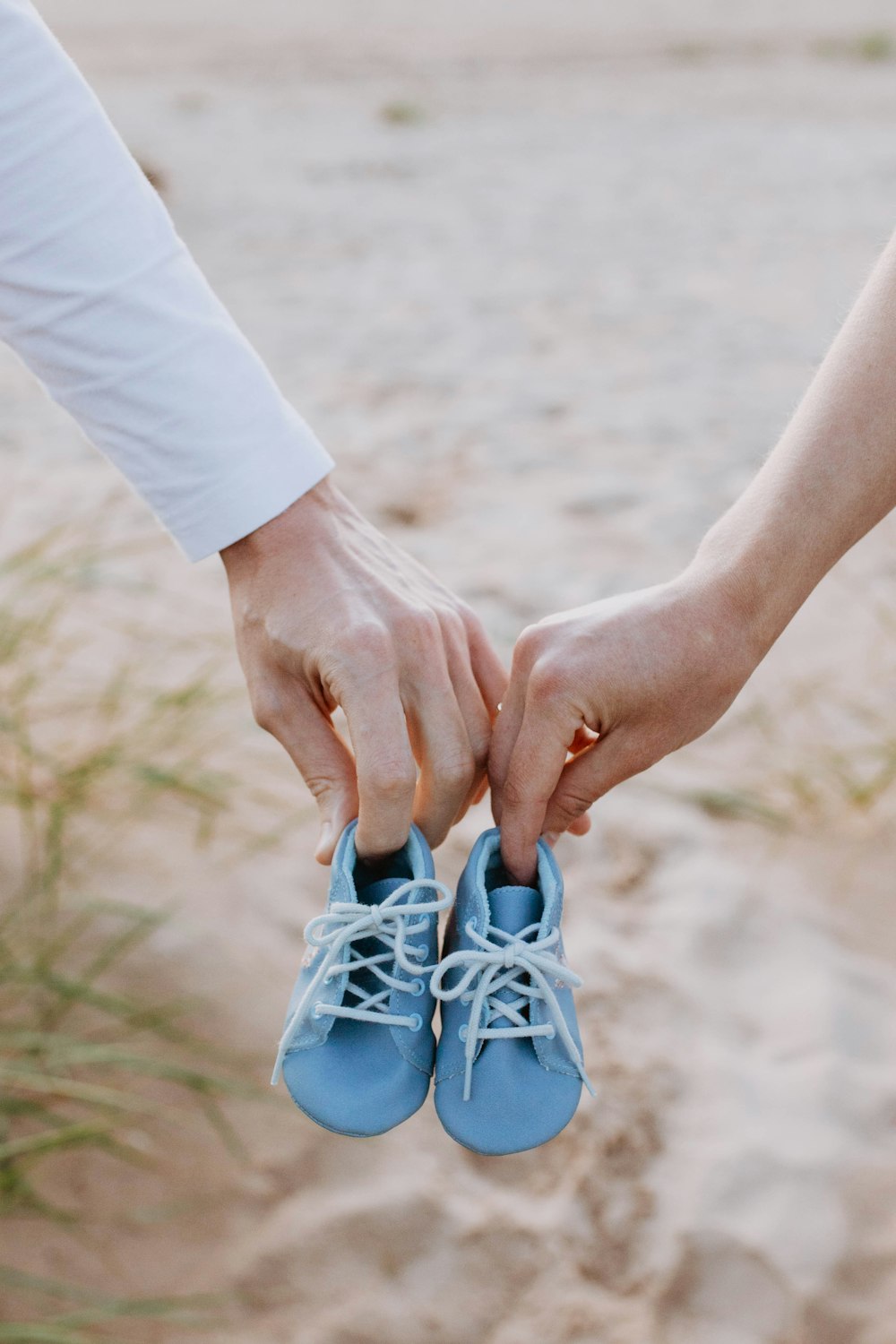 a close up of two people holding hands