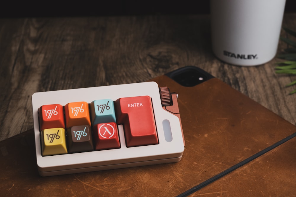 a wooden table topped with a keyboard and a cup of coffee