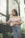 a woman standing in front of a fence