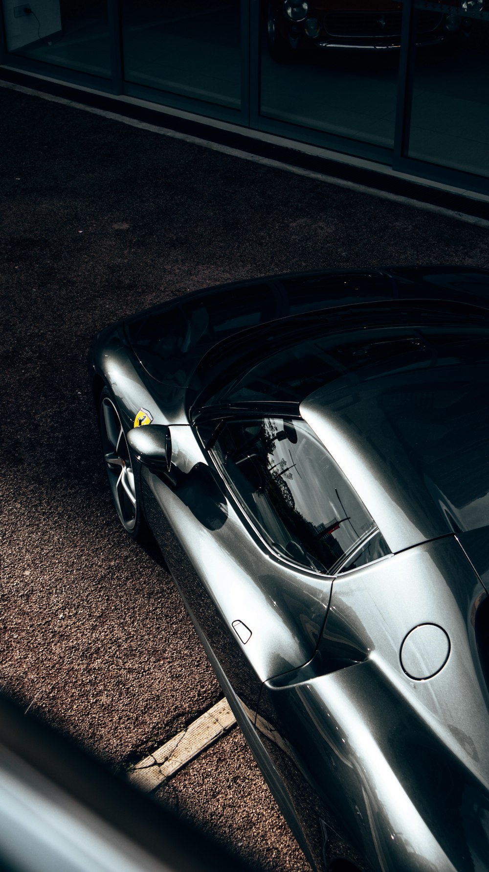 a silver sports car parked in a parking lot