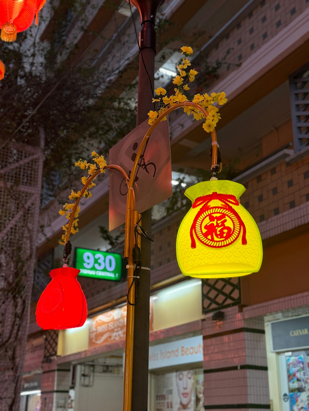 a street light with a yellow bag hanging from it's side