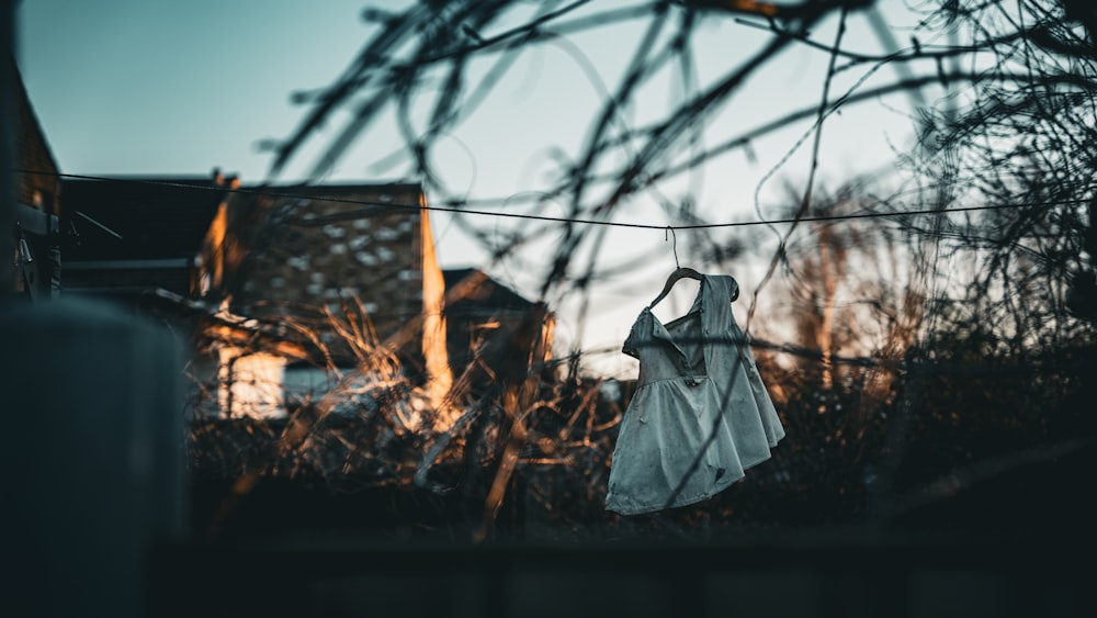 a white dress hanging on a clothes line