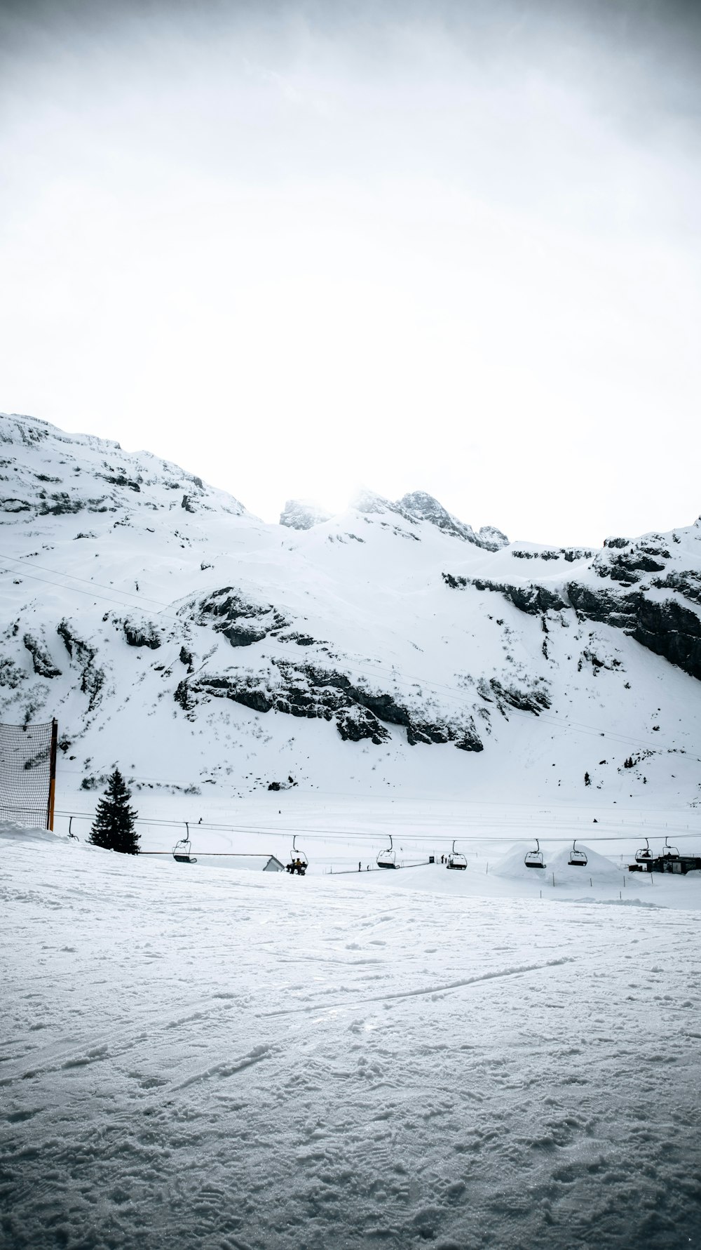 a snowy landscape with a mountain in the background