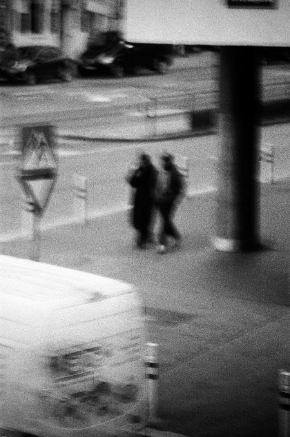 a blurry photo of people walking on a sidewalk