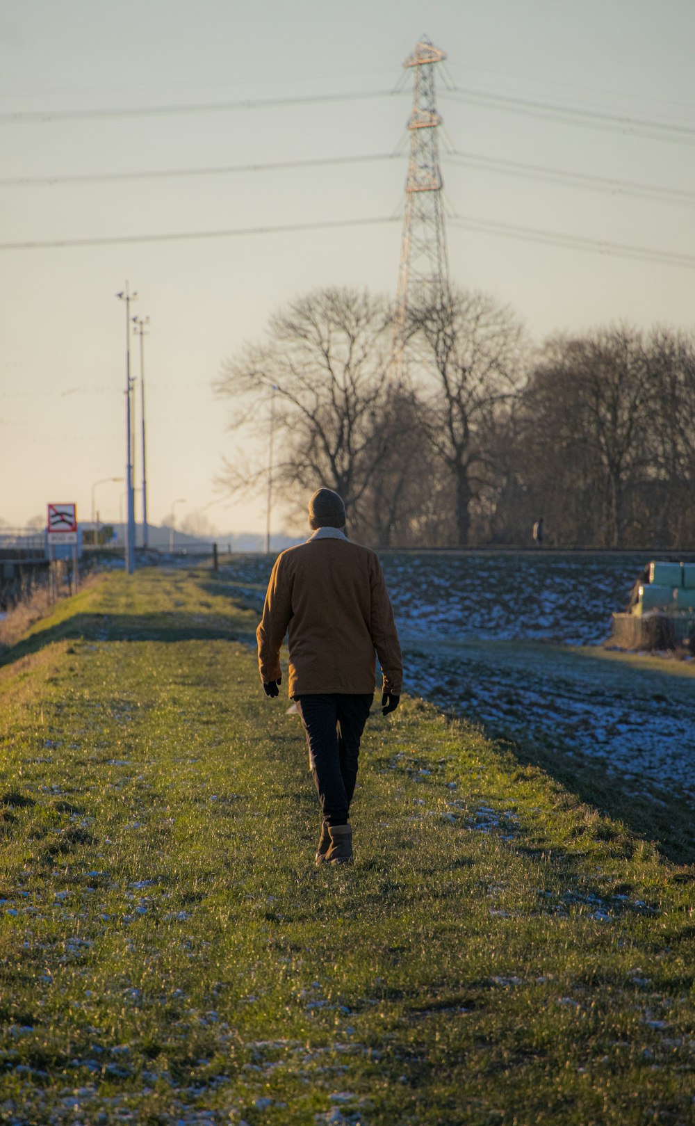 a person walking down a path in a field