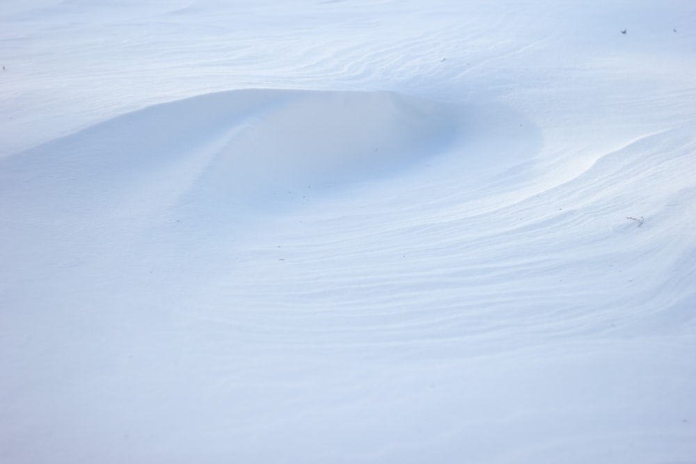 a person riding skis down a snow covered slope