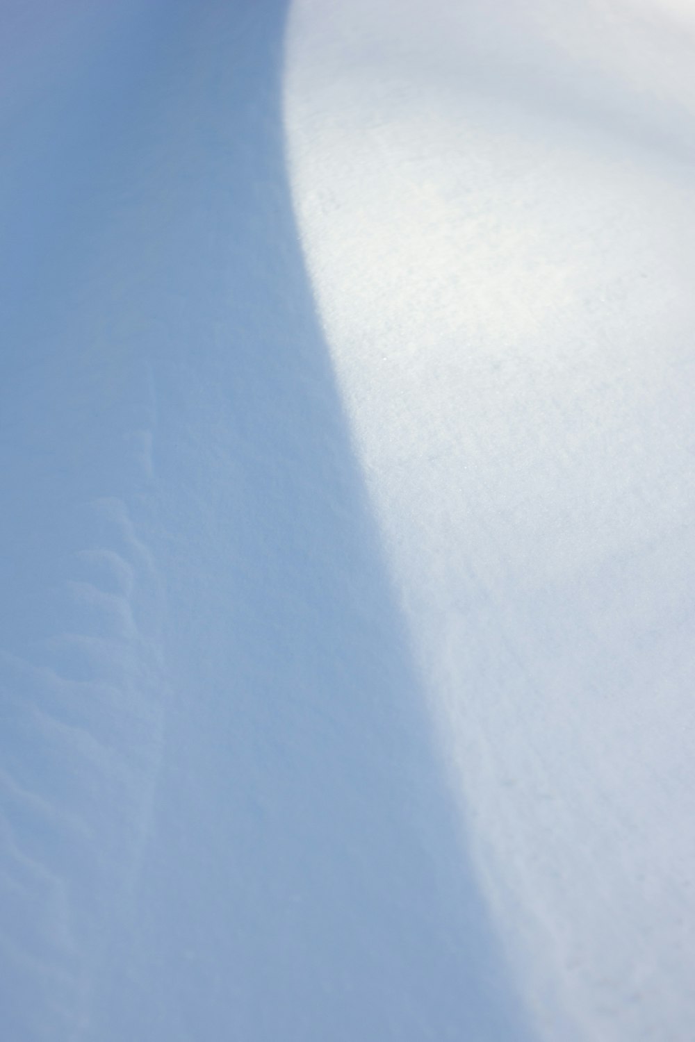 a person riding a snowboard down a snow covered slope