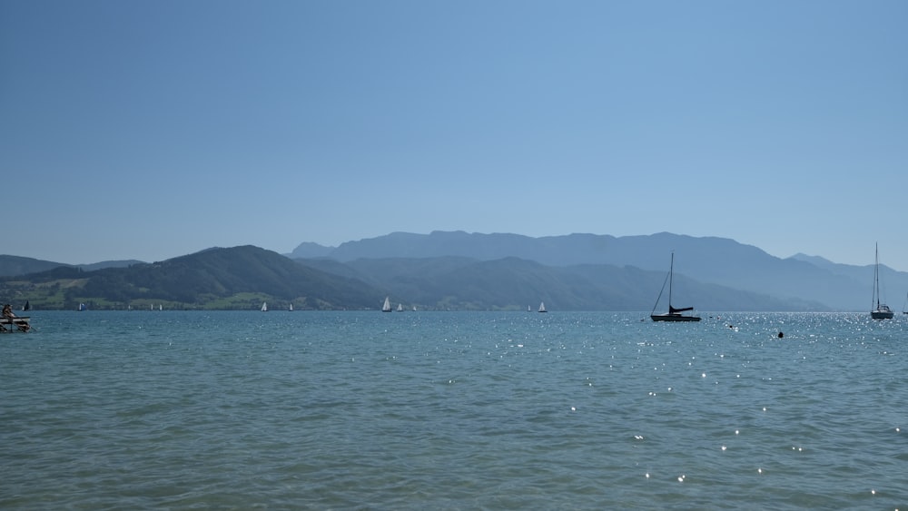 a group of boats floating on top of a large body of water