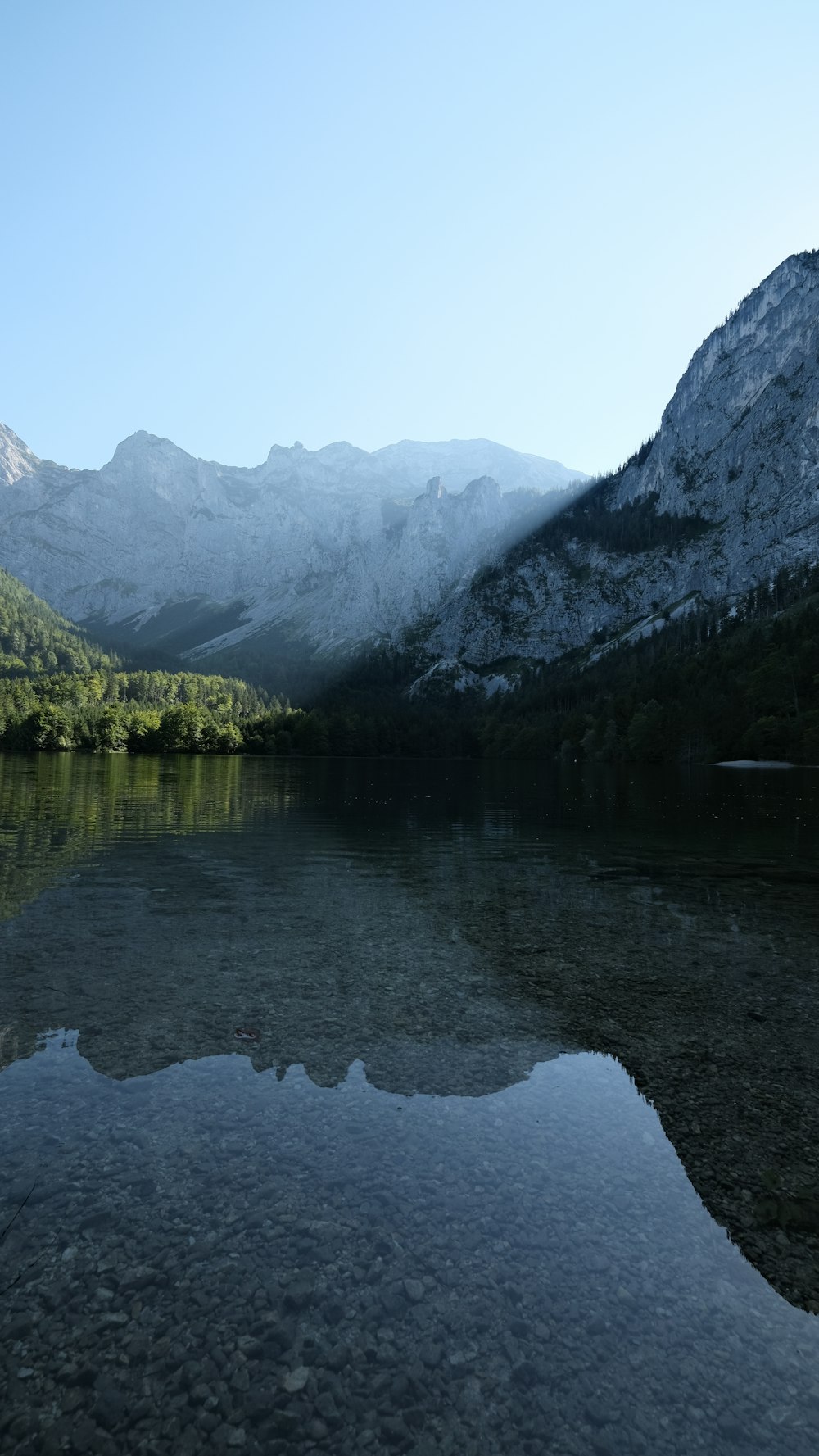 a body of water with mountains in the background