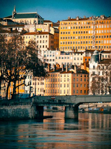 a bridge over a river with lots of buildings in the background