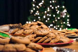 a table topped with plates of cookies and cookies