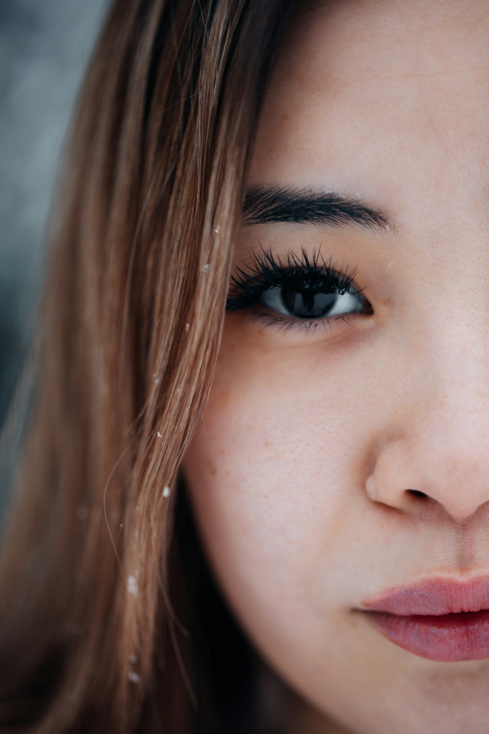 a close up of a woman's face with long hair