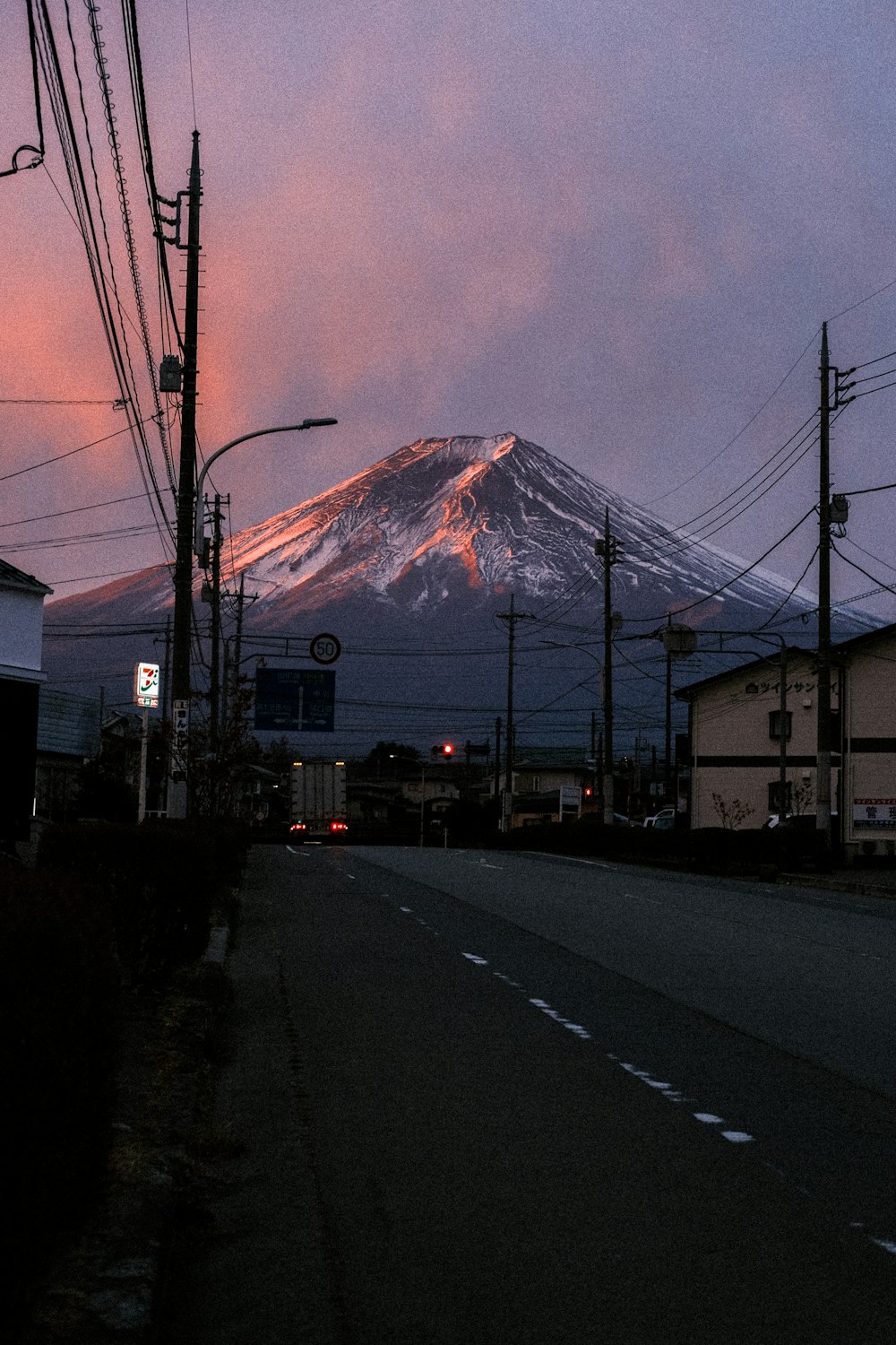 a view of a snow covered mountain at dusk