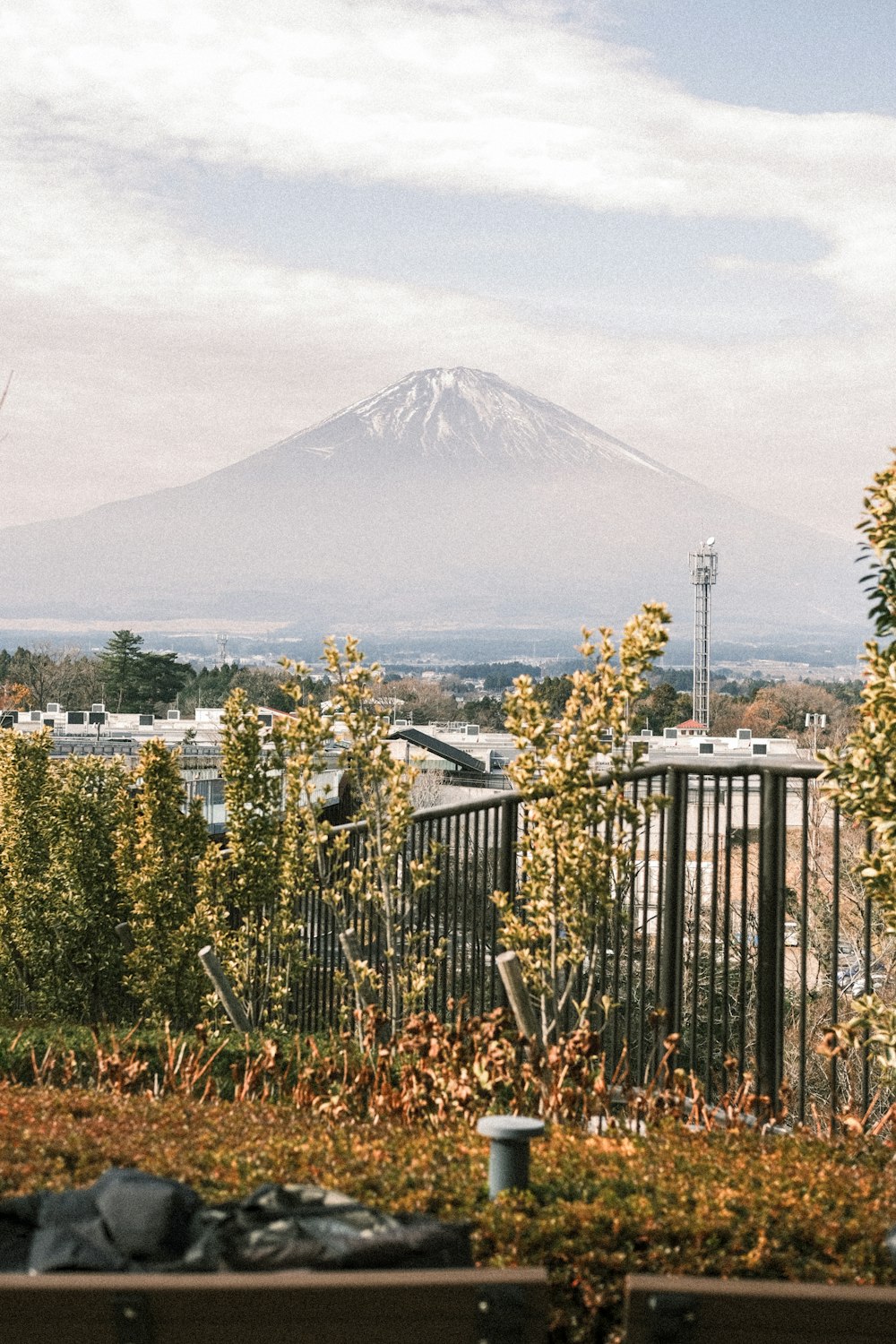 a view of a mountain in the distance from a park bench