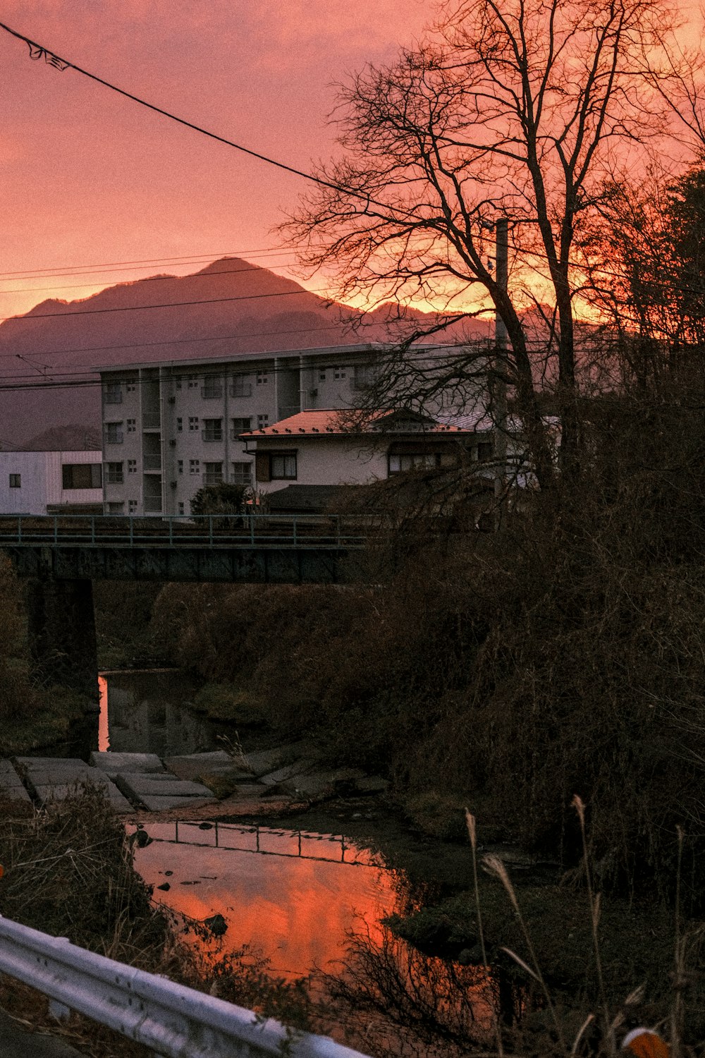 a bridge over a river with a building in the background