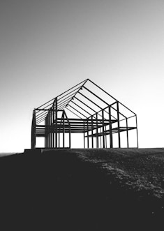a black and white photo of a building under construction