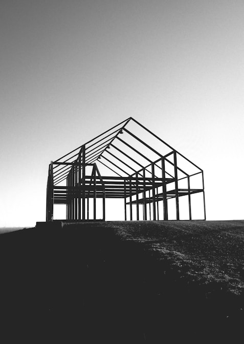 a black and white photo of a building under construction