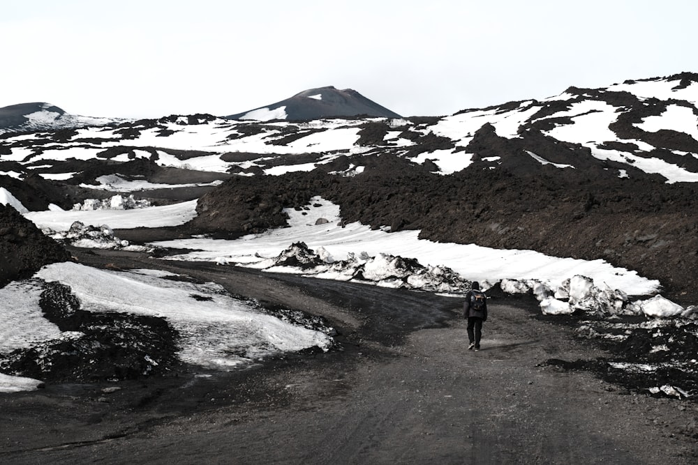 a person is walking down a snowy road