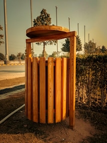 a wooden structure sitting in the middle of a field