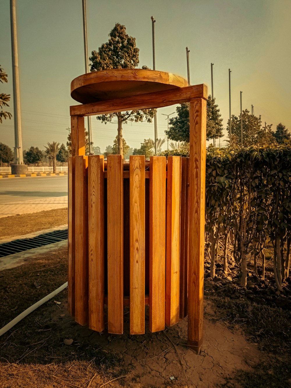 a wooden structure sitting in the middle of a field