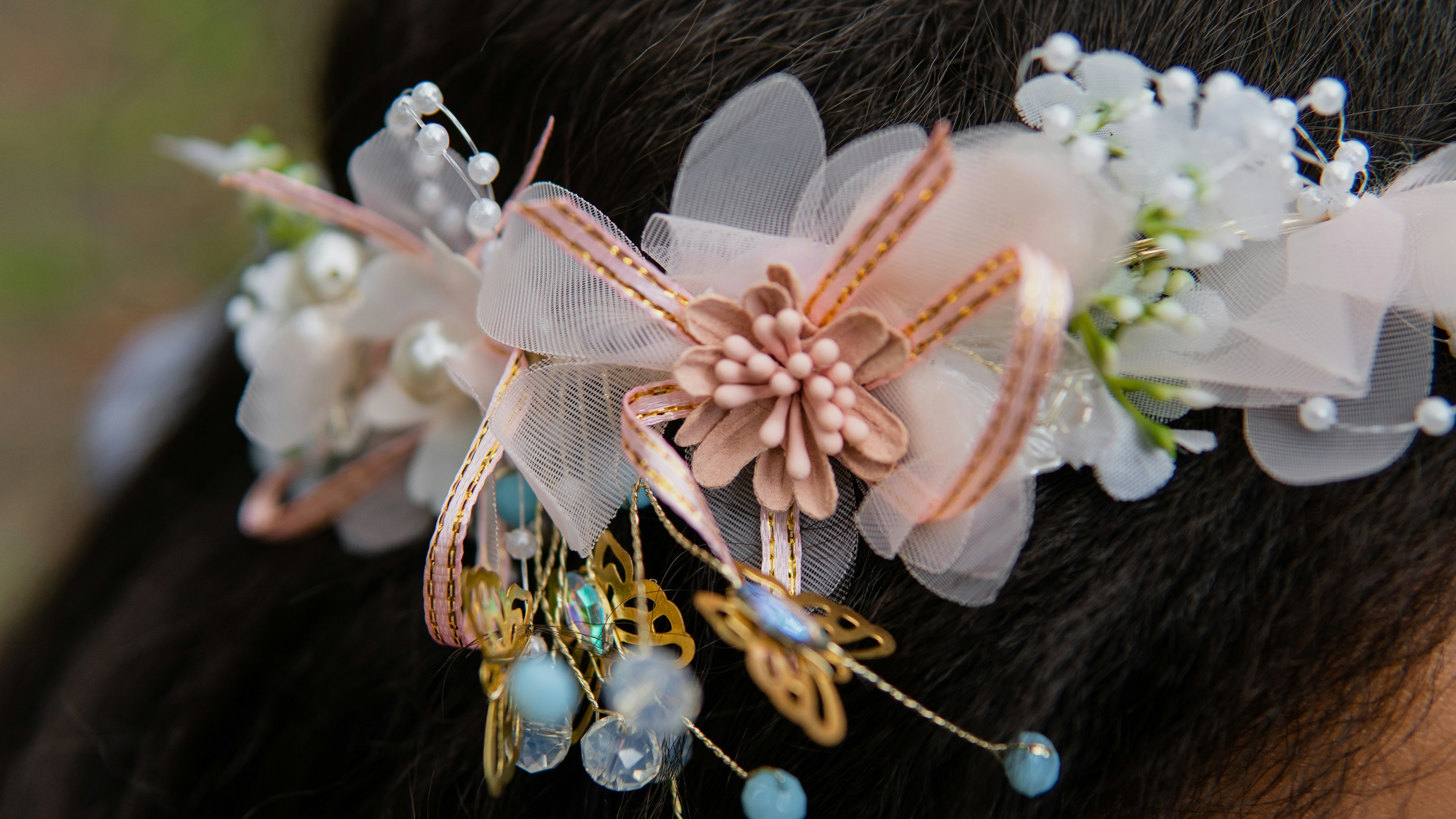 a close up of a woman's head wearing a hair piece with flowers and