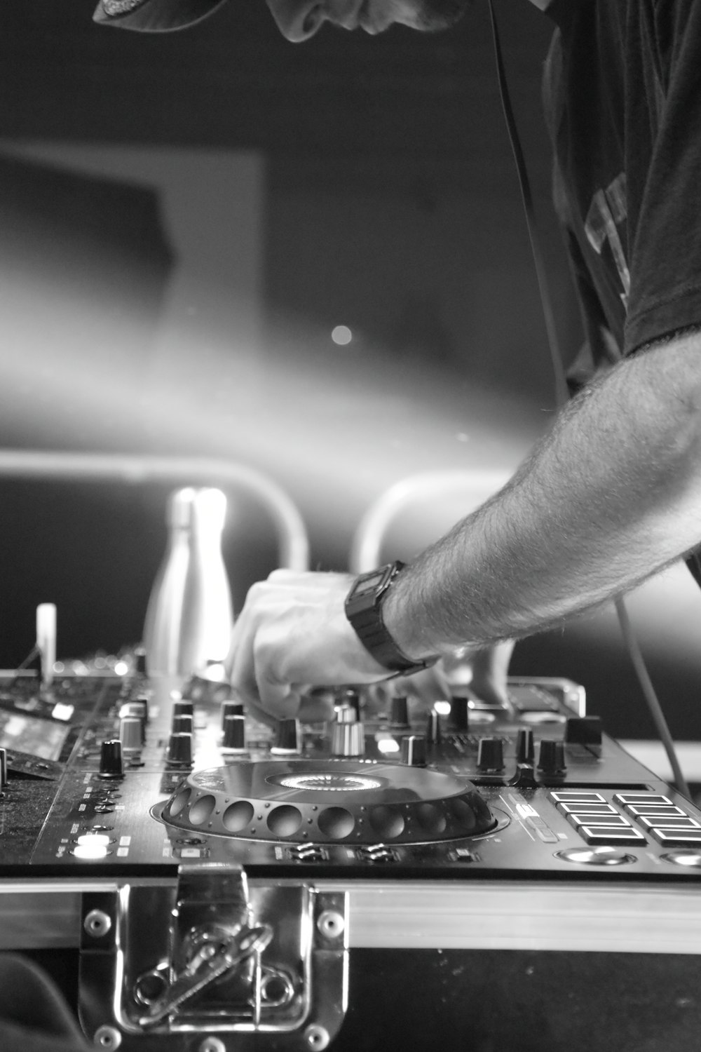 a man that is standing in front of a dj's mixer