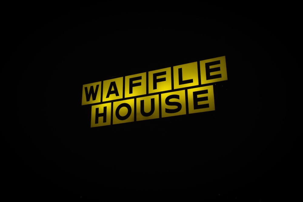 a yellow sign that says waffle house on it