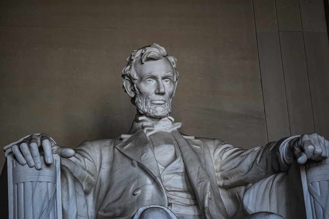 a statue of abraham lincoln holding a cane, A Statue of Abraham Lincoln at the Lincoln Memorial in Washington DC