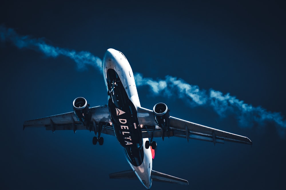 a large jetliner flying through a blue sky