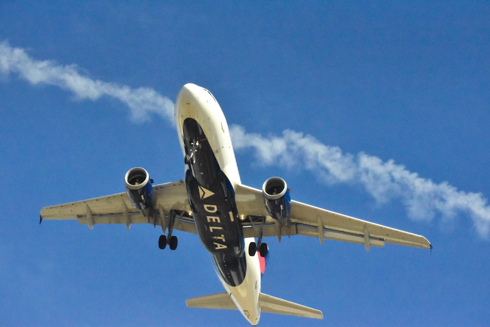 a large jetliner flying through a blue sky