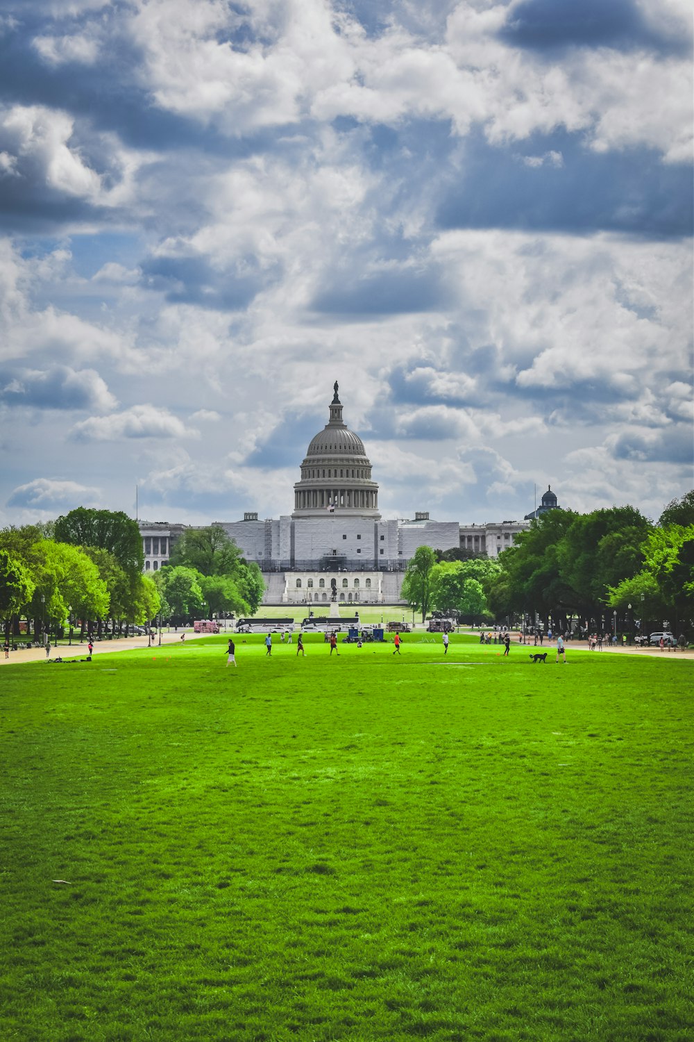 a large building with a green field in front of it