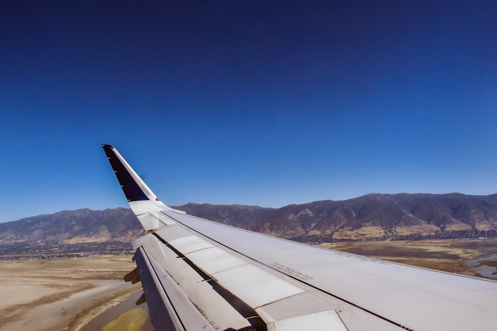 a view of the wing of an airplane in the sky