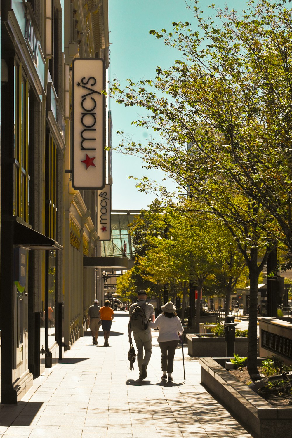 a couple of people that are walking down a sidewalk