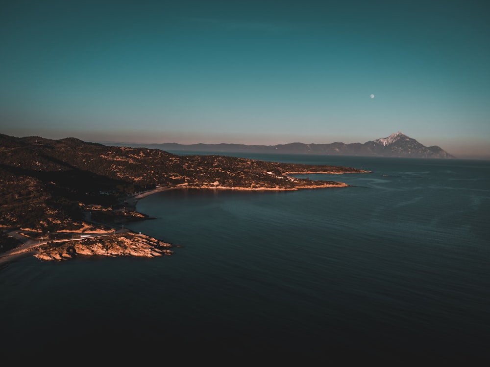 a body of water with a mountain in the background