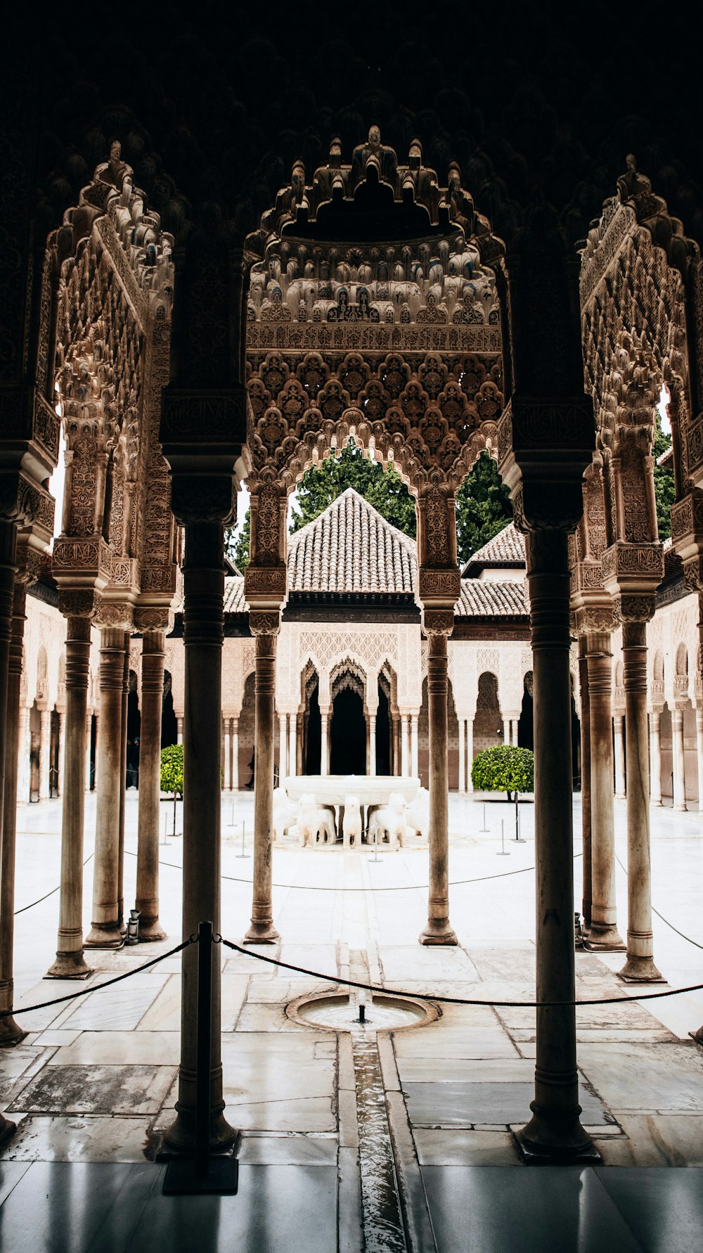 a courtyard with a fountain surrounded by pillars