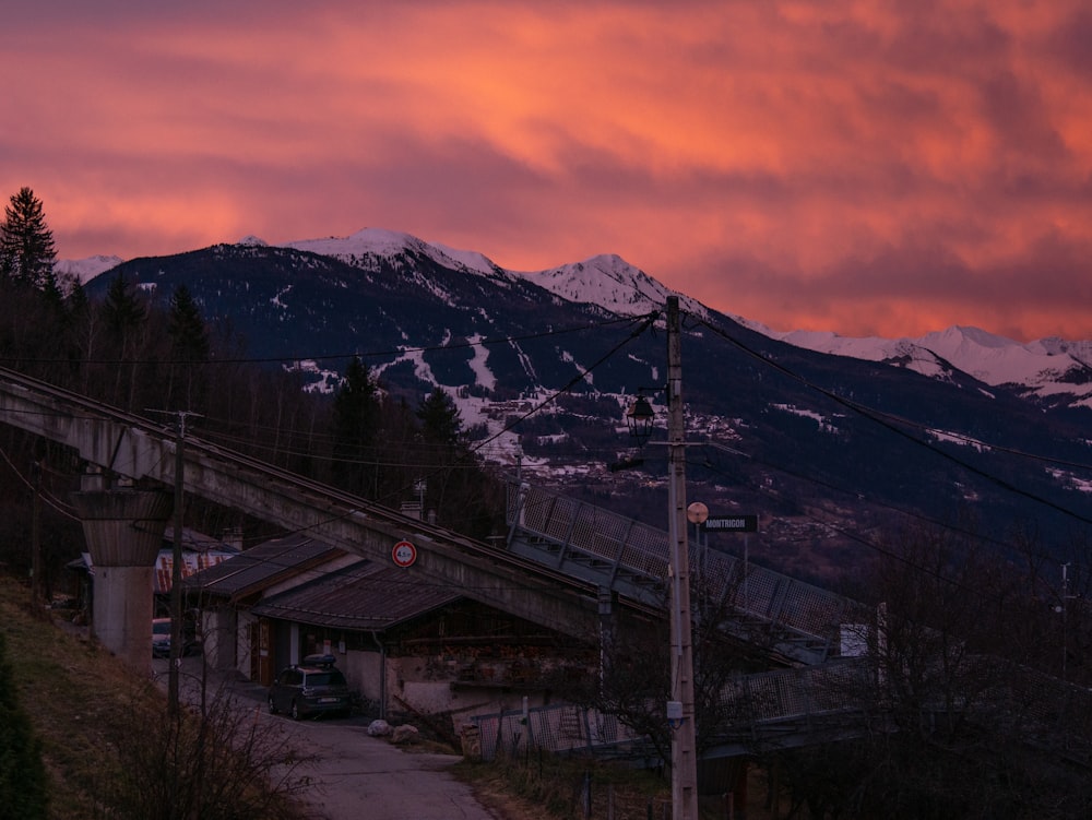 a mountain covered in snow with a red sky