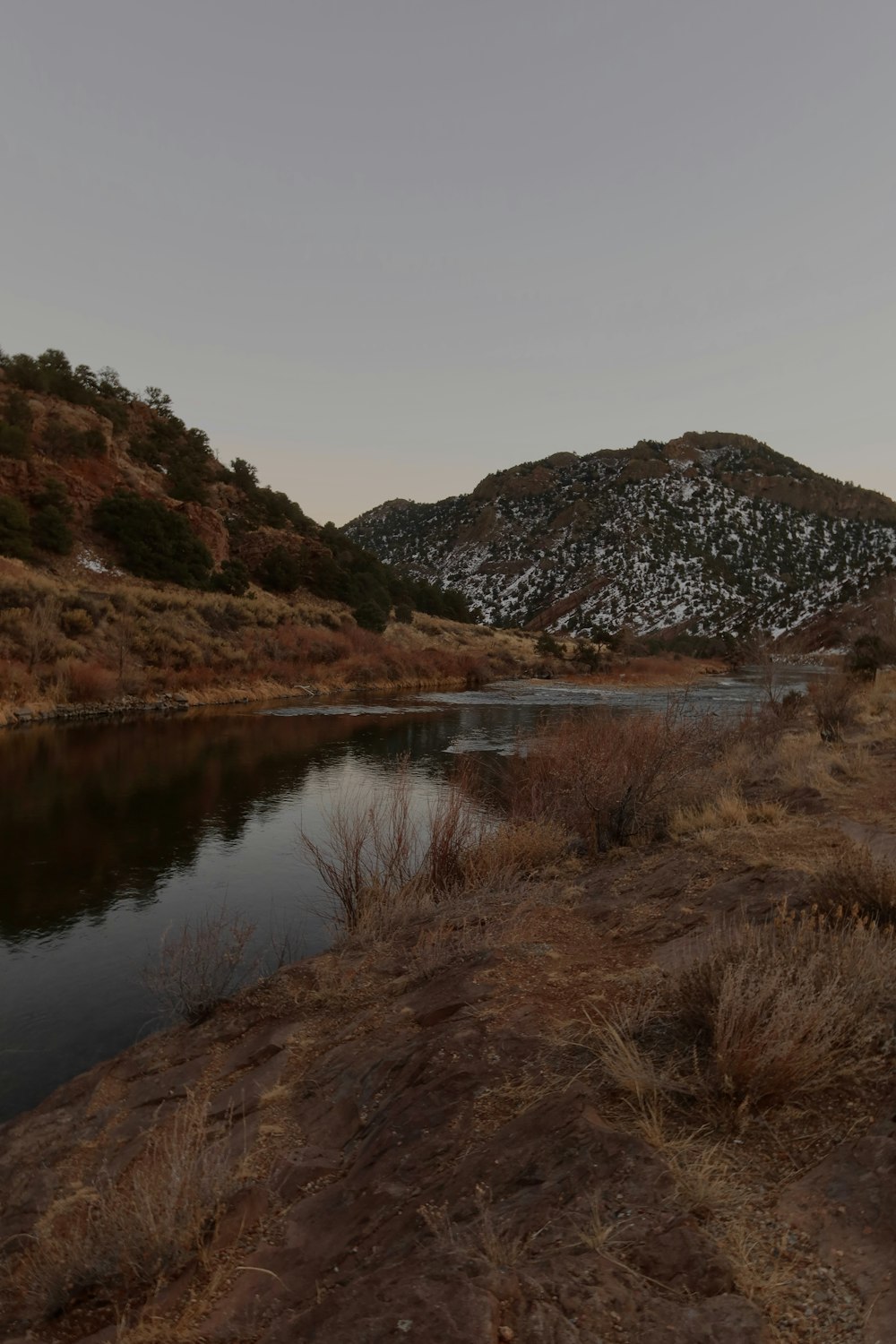 a body of water in a dry grass field