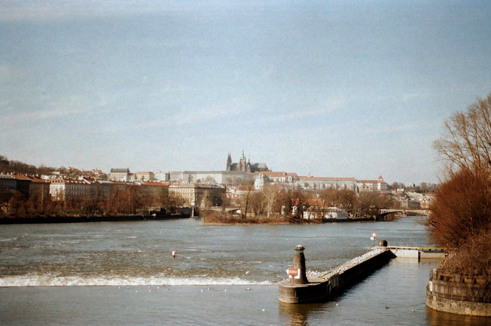 a body of water with a city in the background