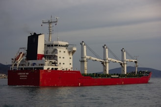a large red and white boat in the water