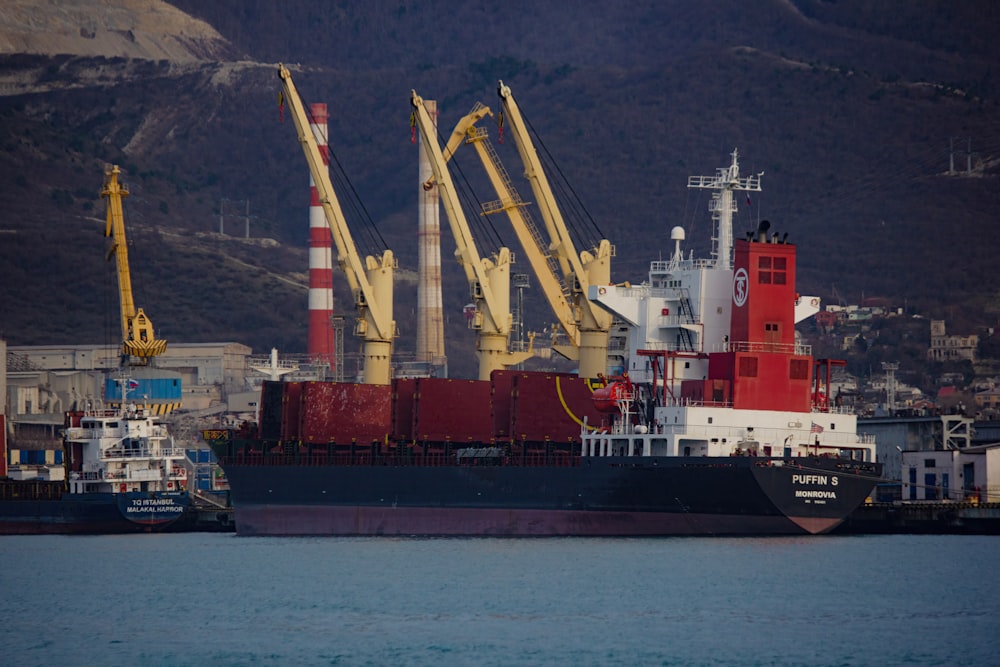 a large cargo ship in the water near a dock