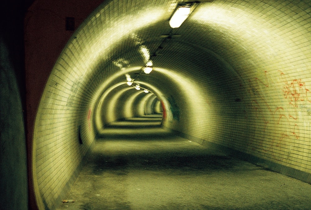 a long tunnel with graffiti on the walls