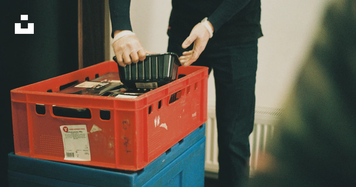 Putting Something In A man is putting something in a plastic container photo – Free Czechia ...