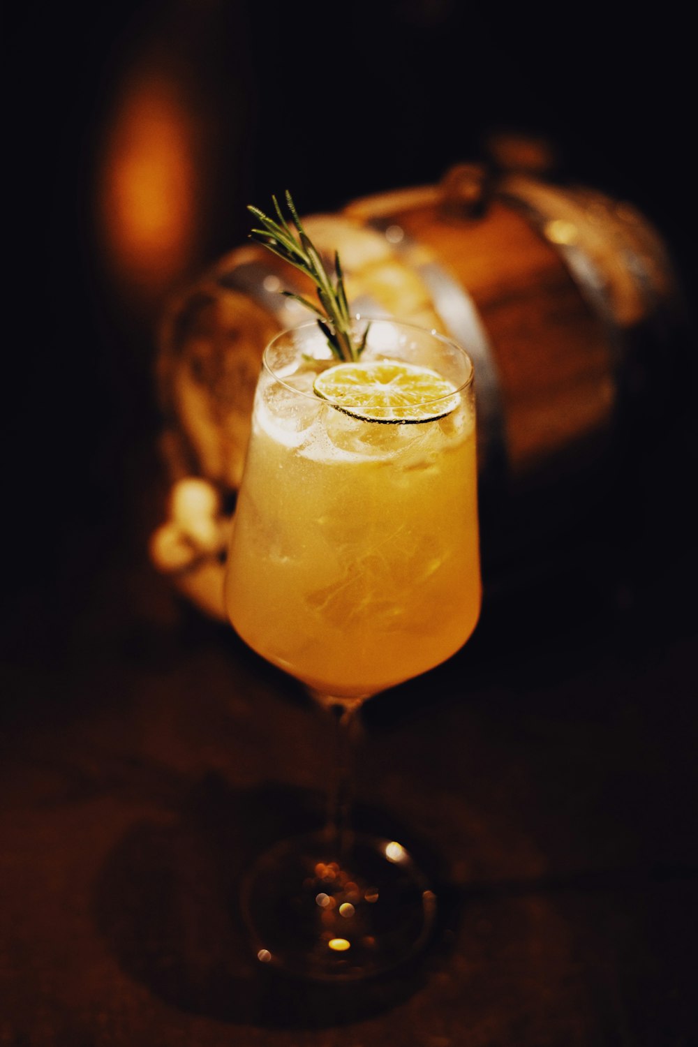 a glass filled with a drink sitting on top of a table