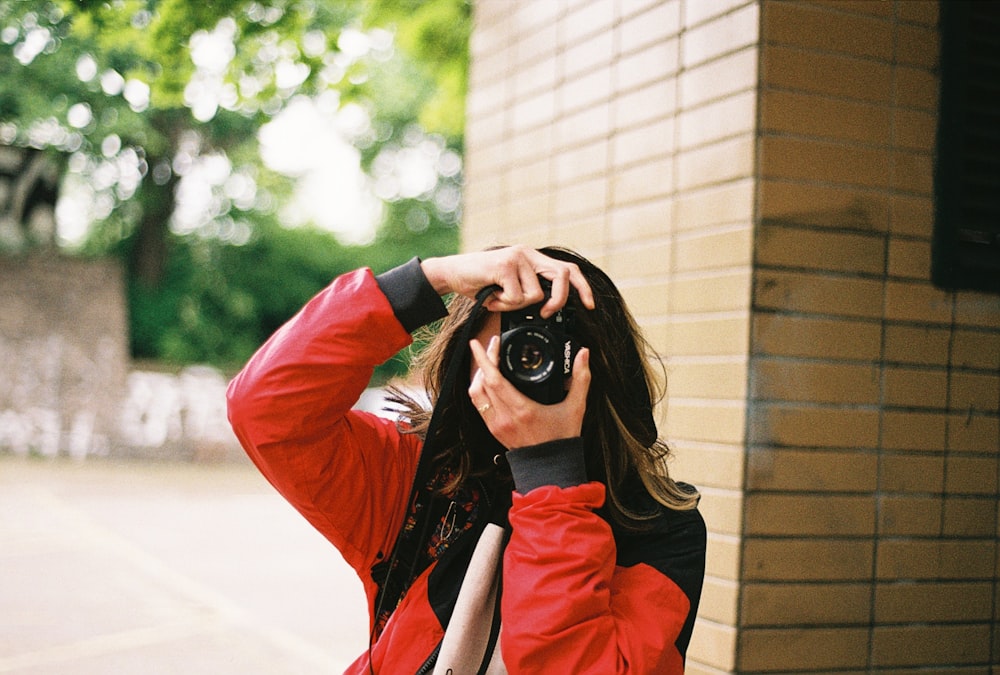 a woman taking a picture of herself with a camera