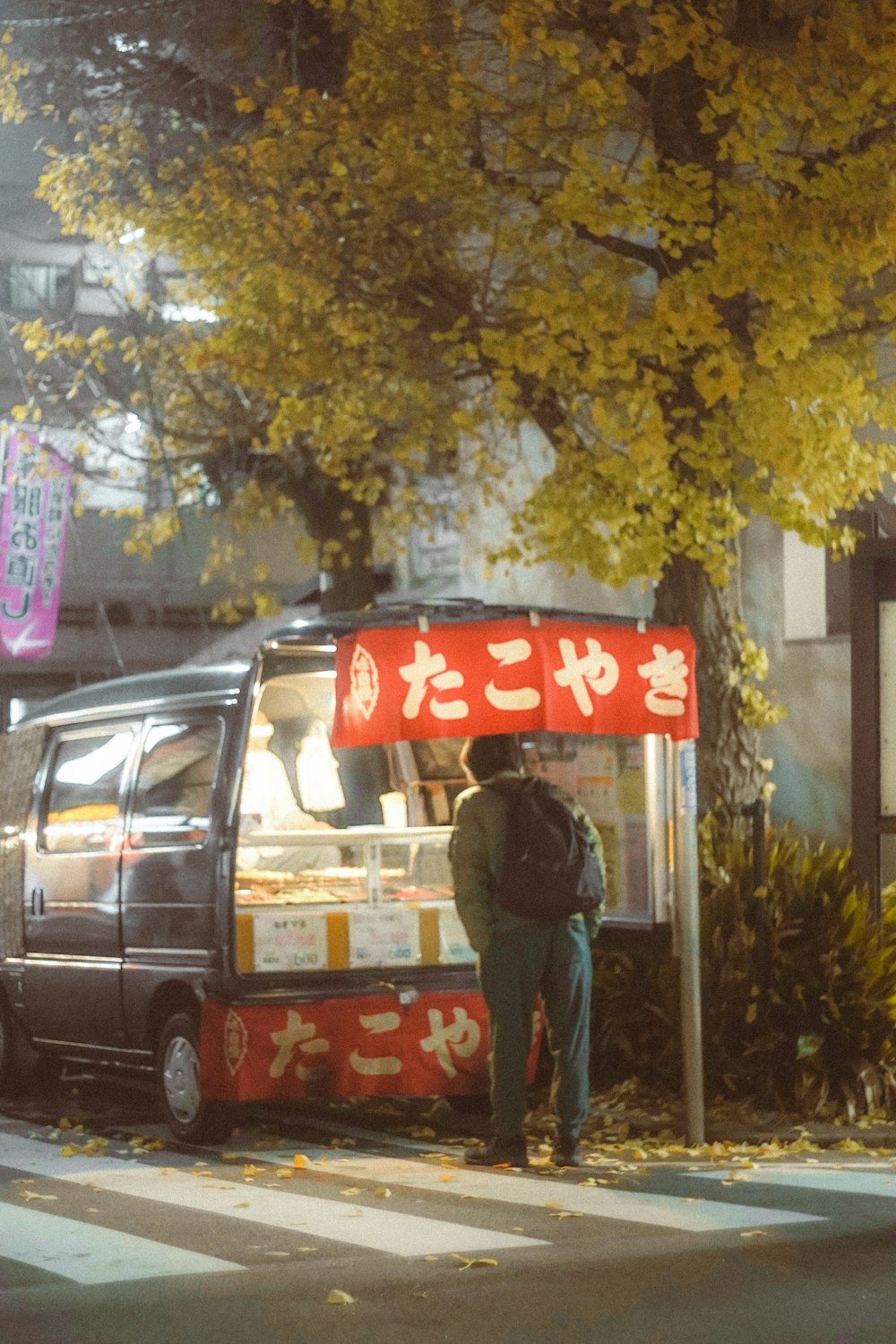 a man standing in front of a food truck