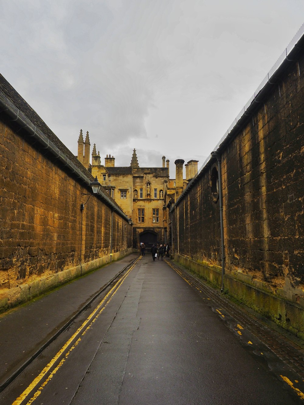 a long narrow street with a building in the background