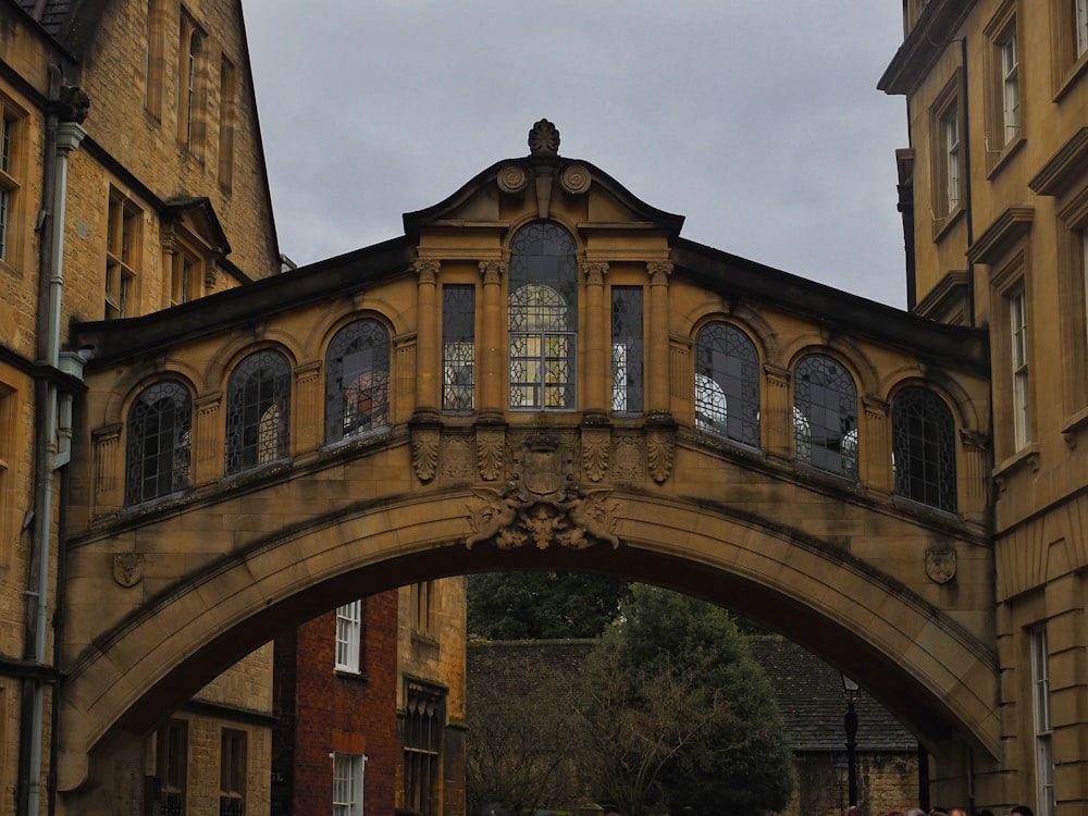 a bridge over a street with people walking under it