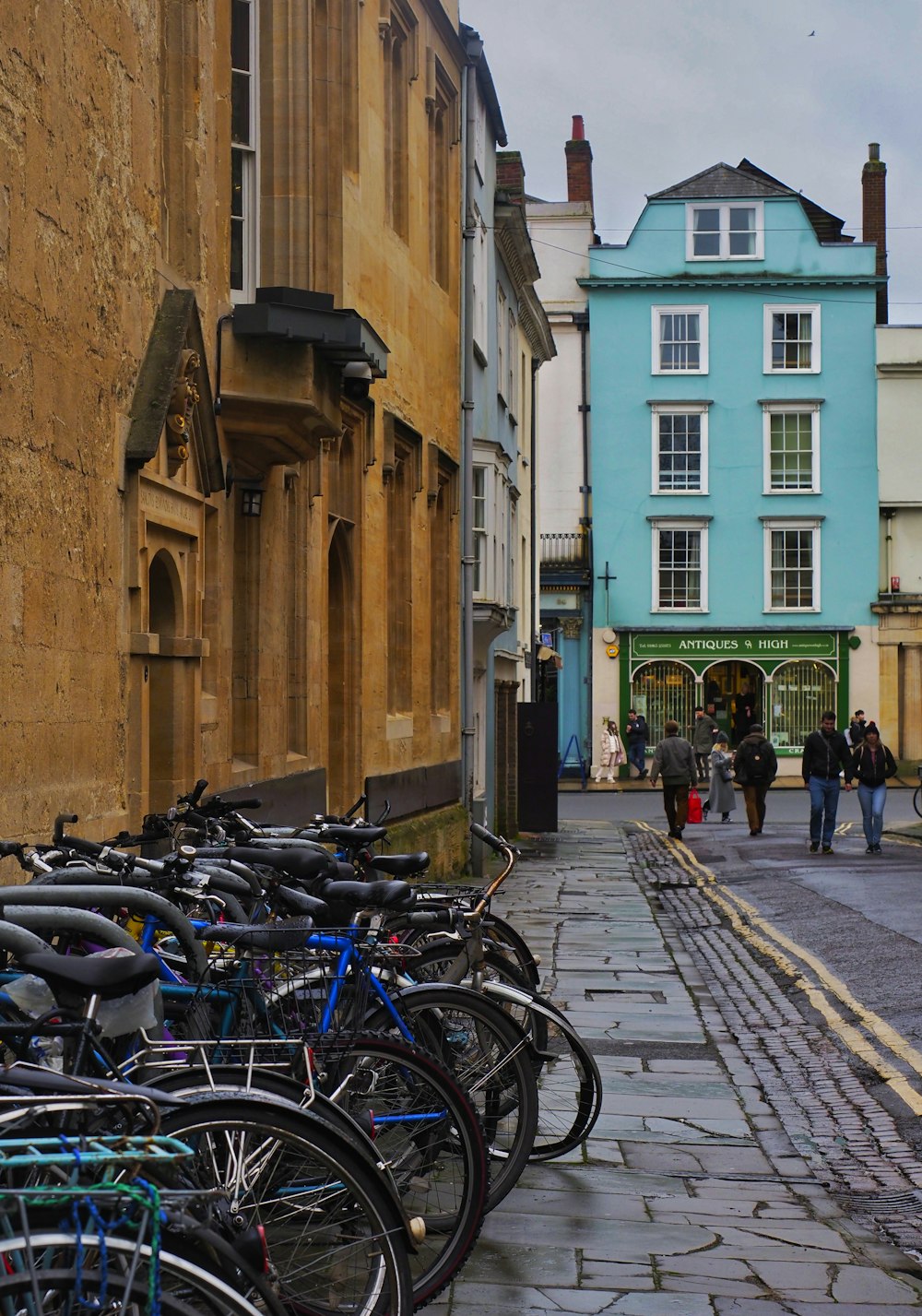 a bunch of bikes parked on the side of a street